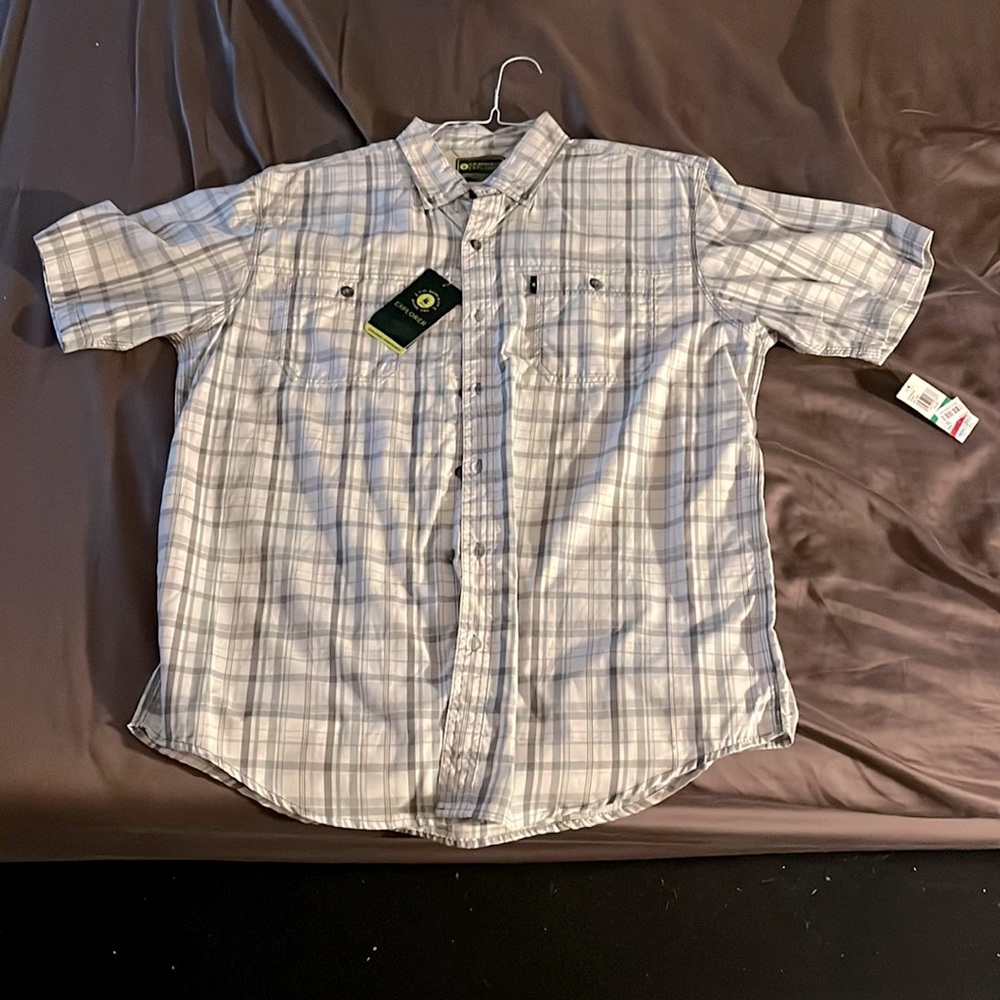 Short sleeve plaid button down shirt. Never worn. Still has the tags on it